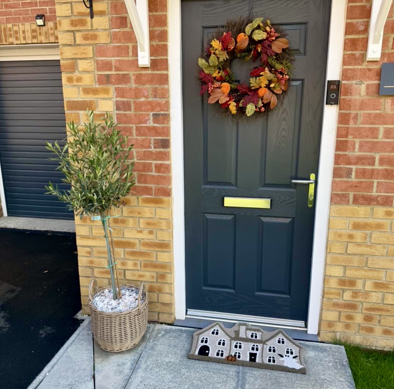 Charming Autumnal Front Door With Wreath And Potted Tree