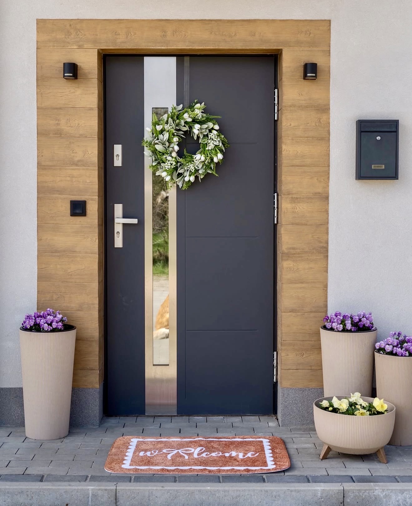 Charming Front Door With Greenery And Purple Flowers