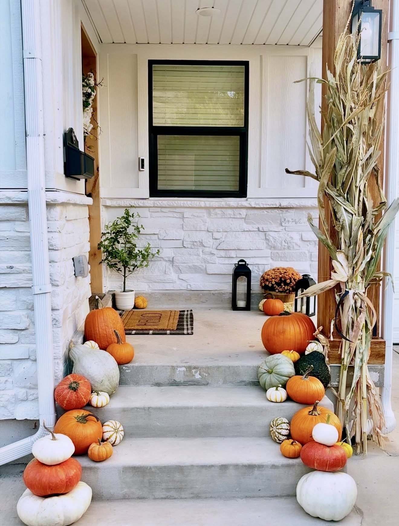 Farmhouse Fall Porch With Abundant Pumpkins