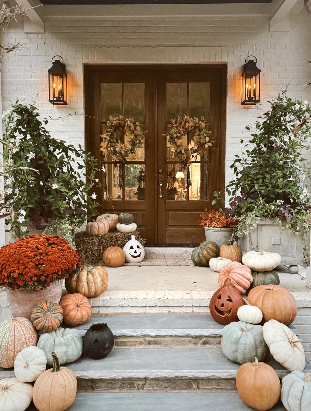 Farmhouse Fall Porch With Pumpkins and Mums
