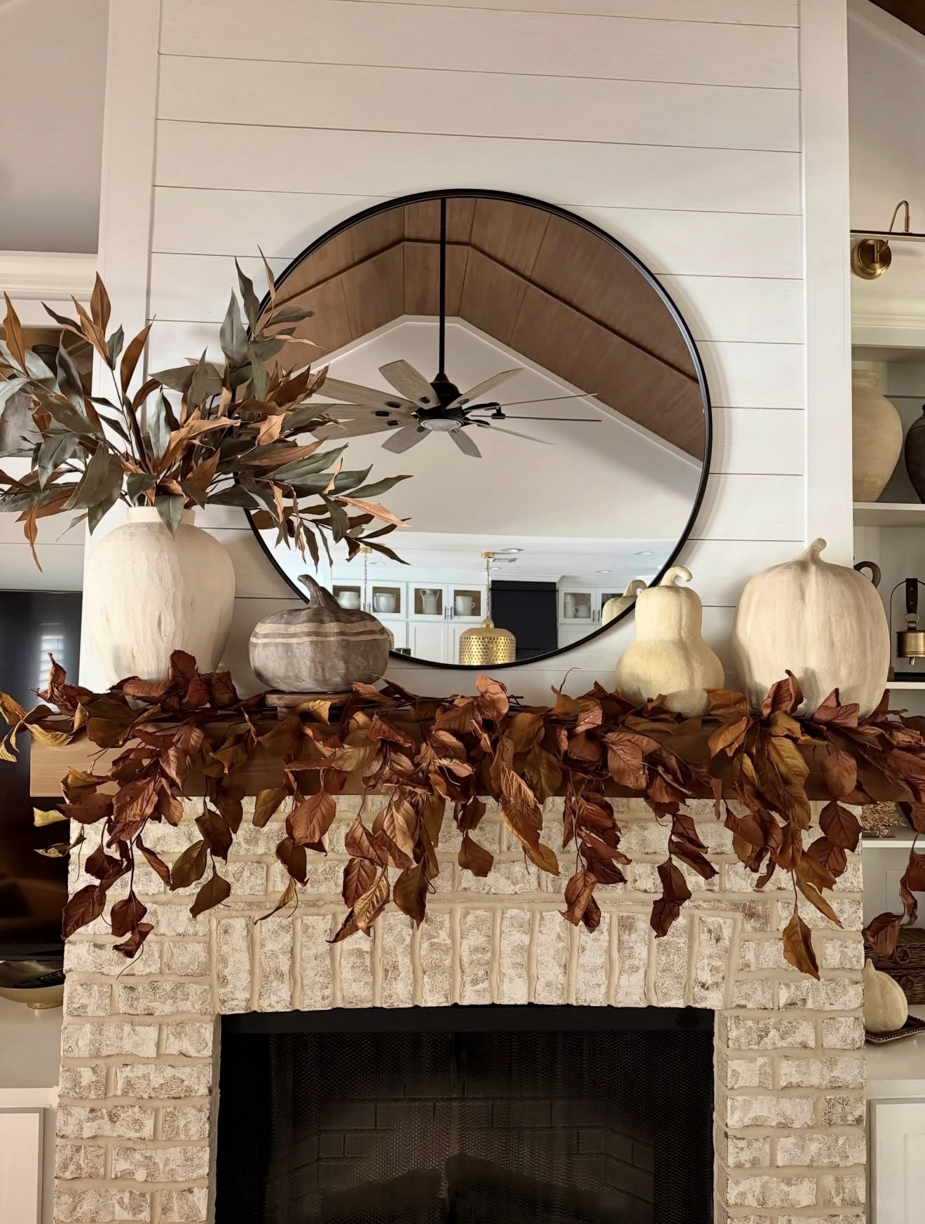 Rustic Fall Mantel with Dried Leaves and Pumpkins