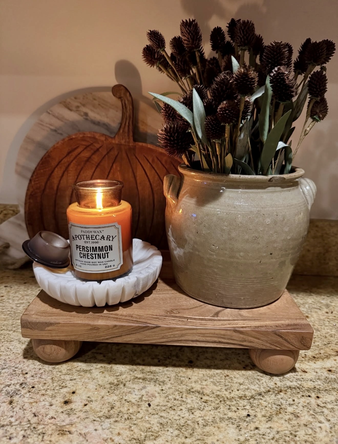 Warm Autumn Vignette With Candle And Dried Stems