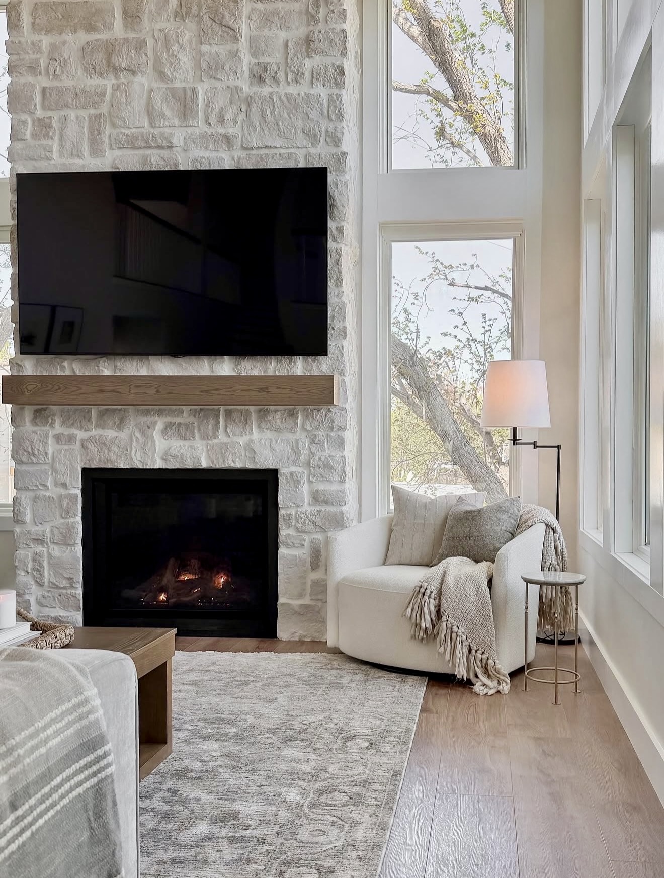 Cozy Cream Swivel Chair by Stone Fireplace