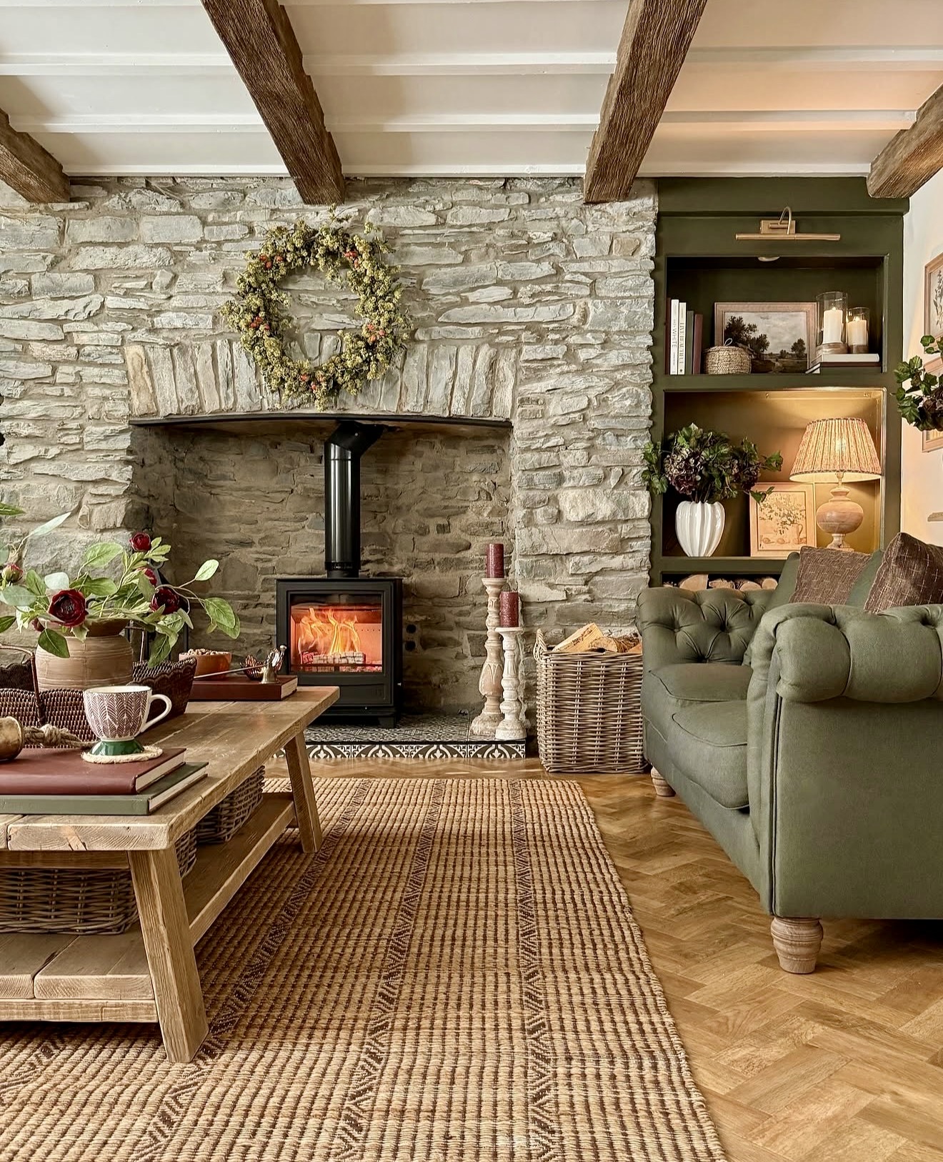 Cozy Stone Fireplace With Green Tufted Sofa