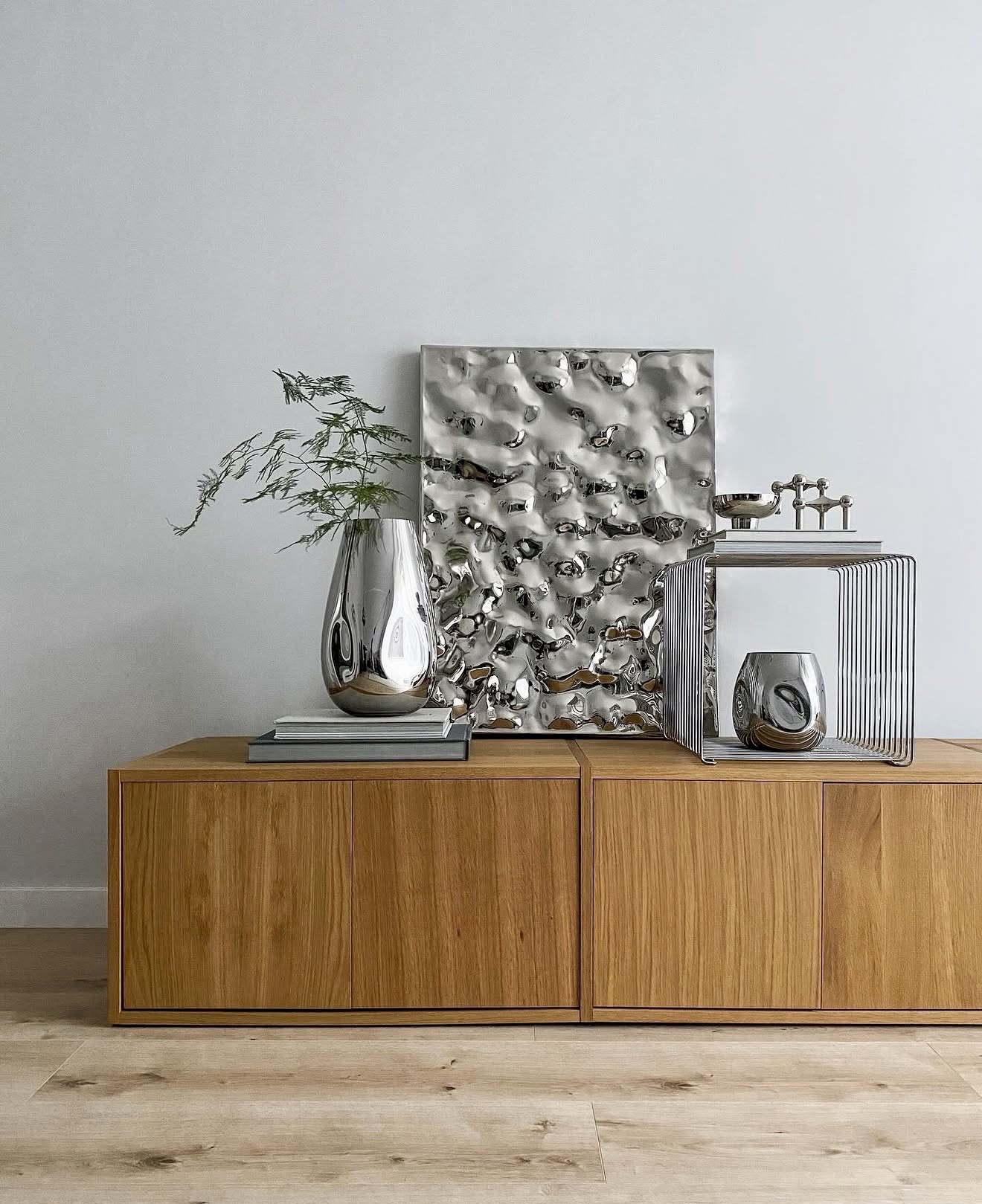Minimalist Oak Cabinet With Reflective Chrome Accents