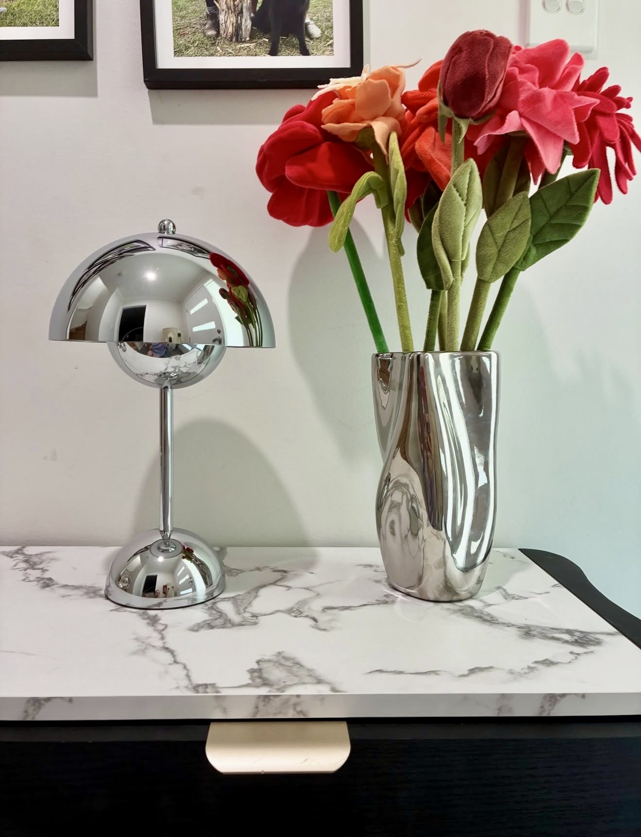 Reflective Chrome Accents On Marble Console