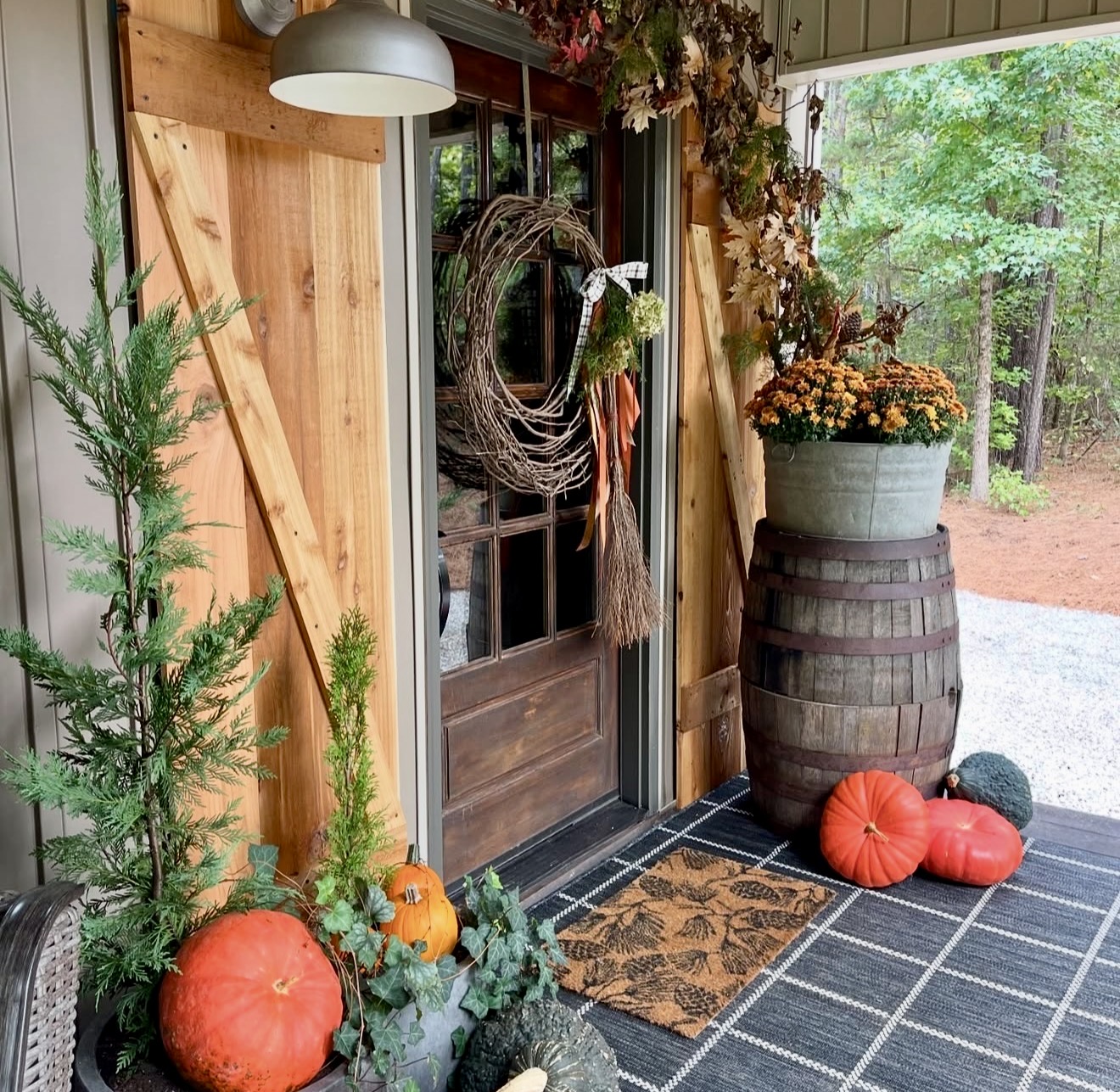 Rustic Fall Porch With Pumpkins And Mums
