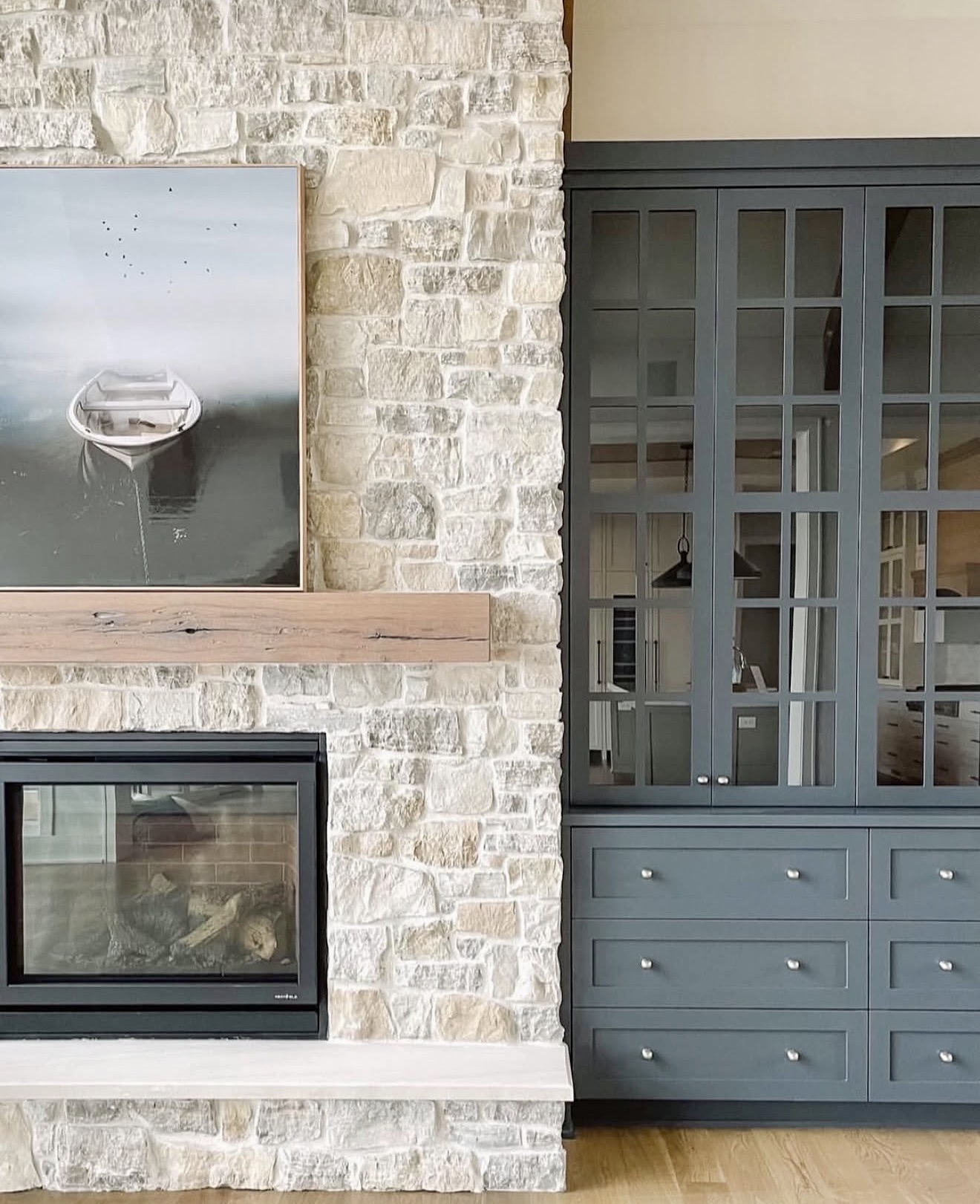 Rustic Stone Fireplace With Modern Gray Built-Ins