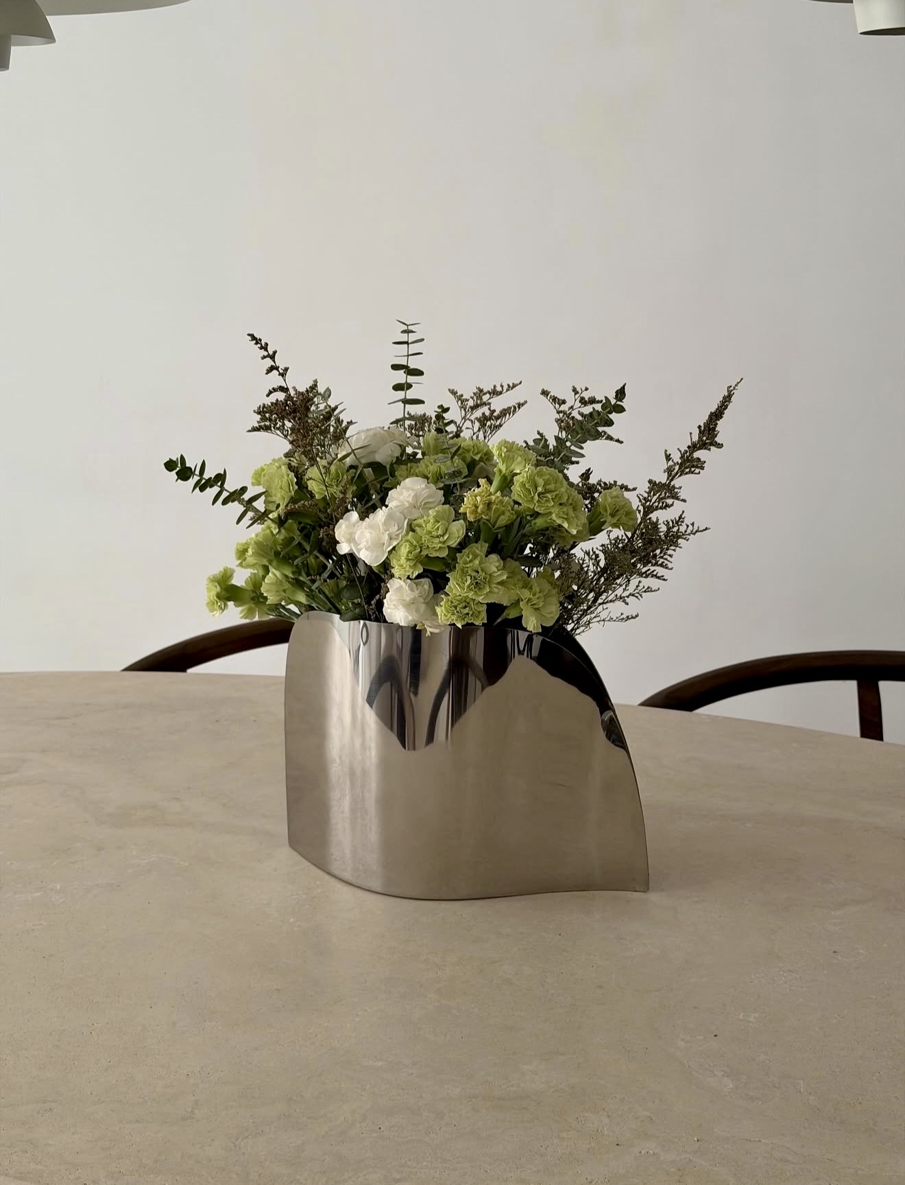 Sculptural Chrome Vase With Fresh Green Florals