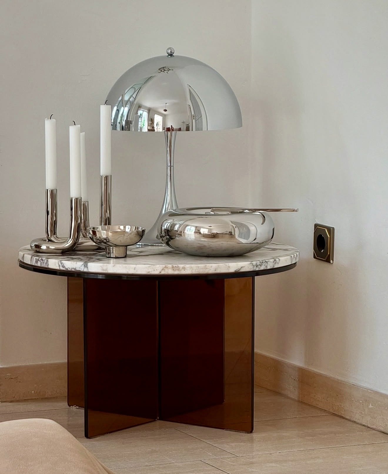 Sleek Chrome Accents On A Modern Pedestal Table