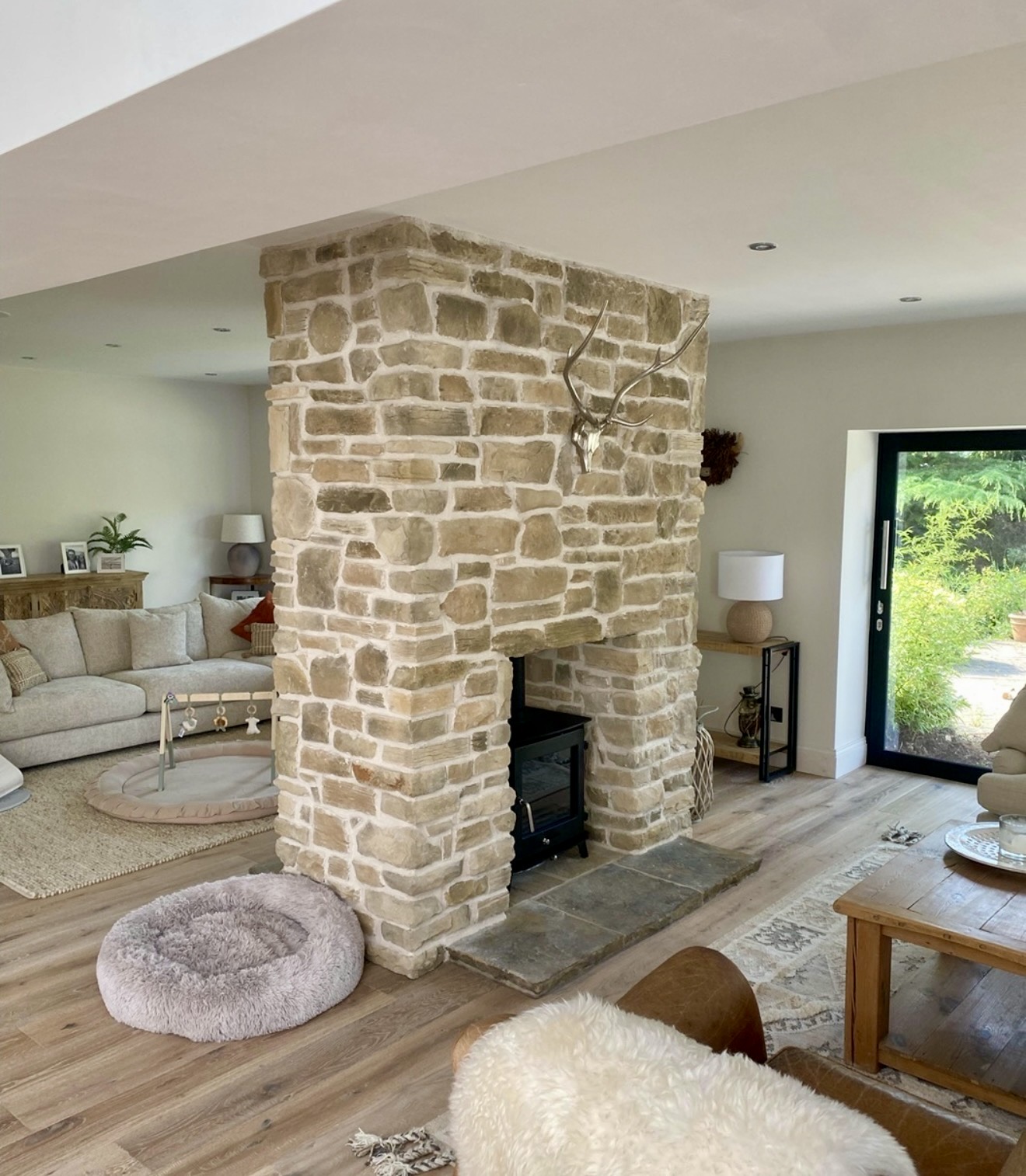 Textured Stone Fireplace With Modern Wood Stove