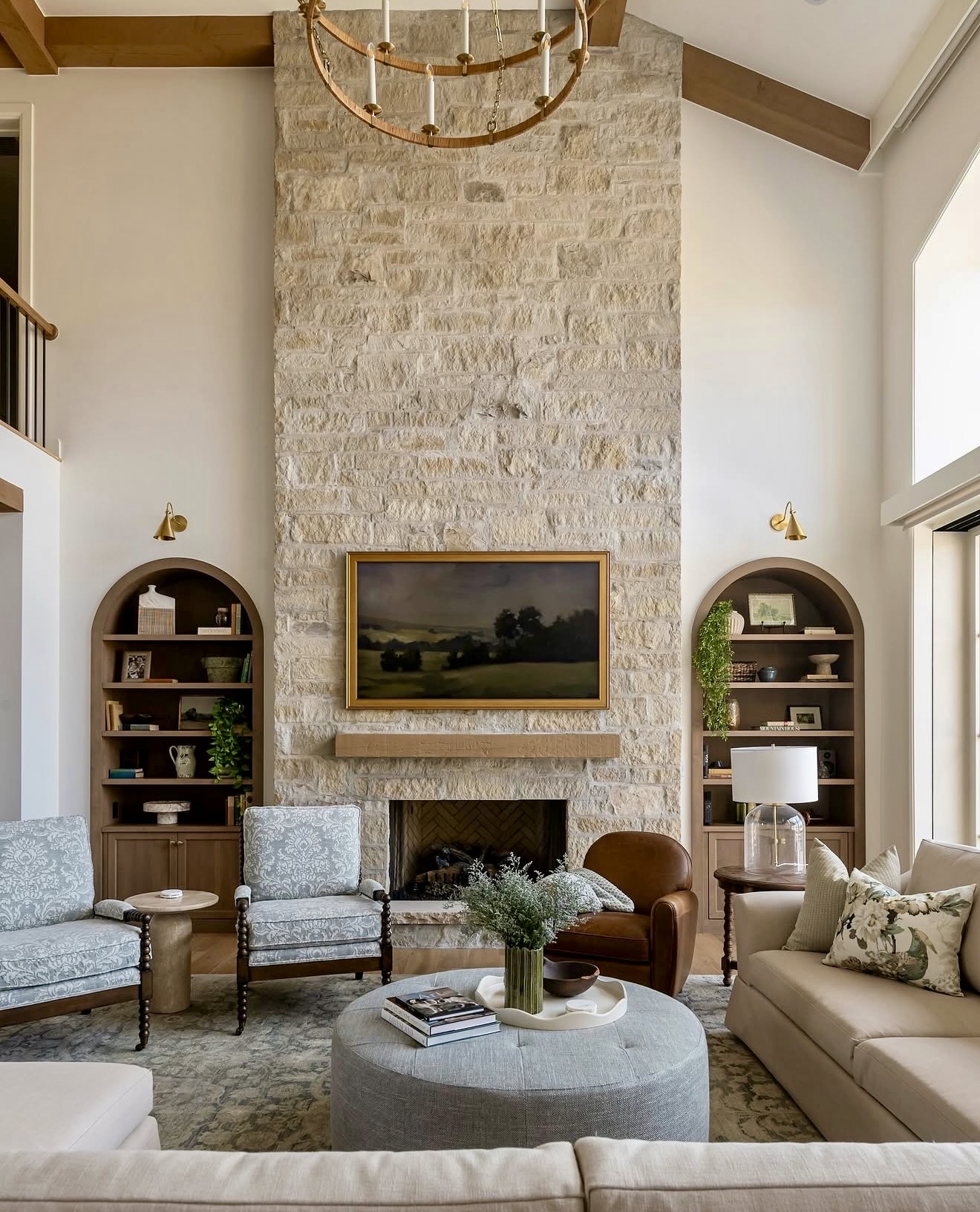 Towering Stone Fireplace With Arched Built-In Bookcases
